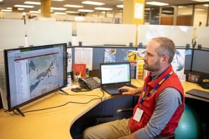 photo of a male dispatcher looking at computer screens