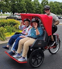 photo of electric rickshaw bike with two passengers